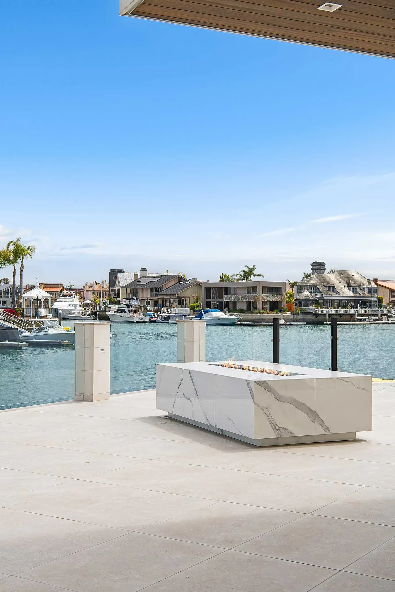 A white marble table is sitting on a dock overlooking a body of water.