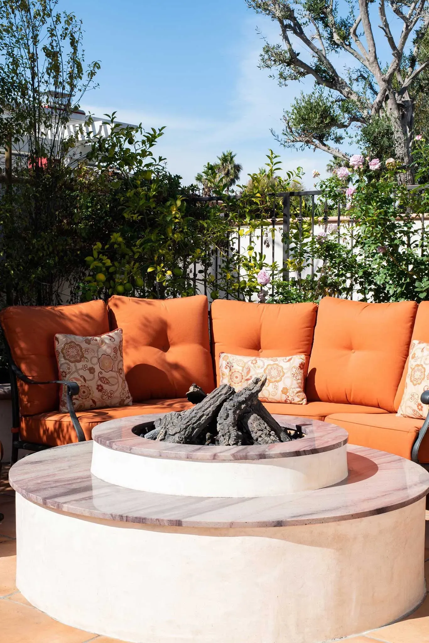 There is a fire pit in the middle of the patio.