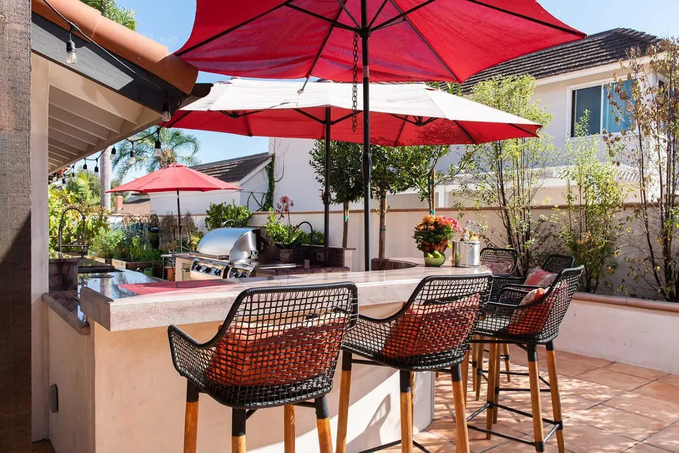 A patio with a table and chairs and umbrellas