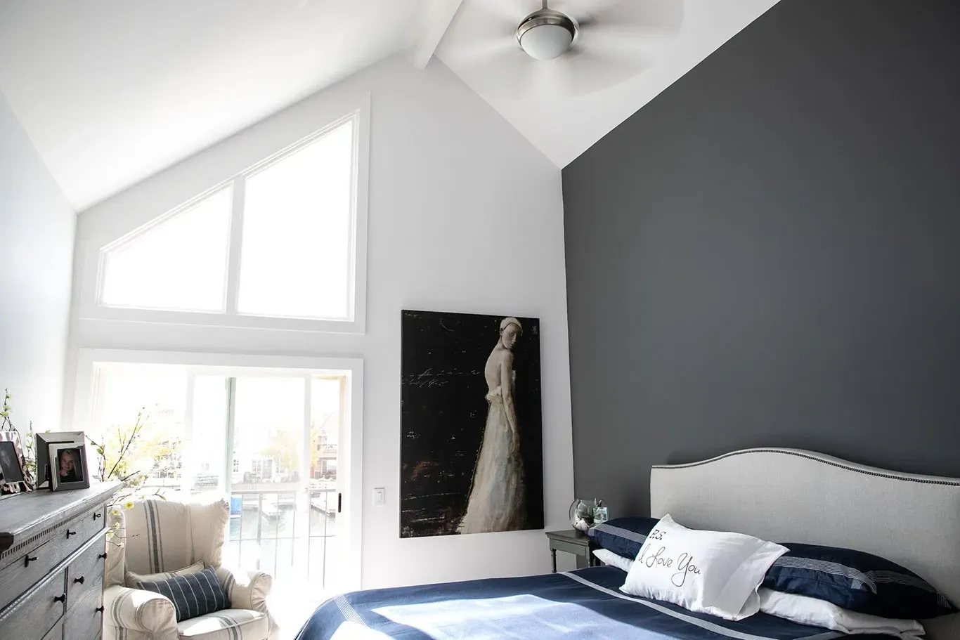 A bedroom with a bed and a painting on the wall