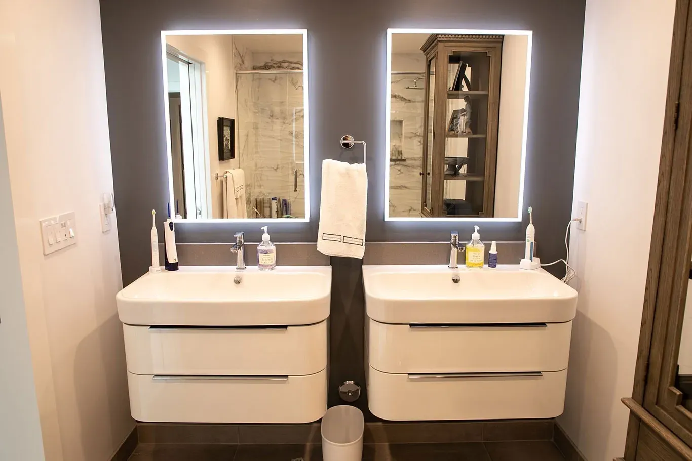 A bathroom with two sinks and two mirrors.