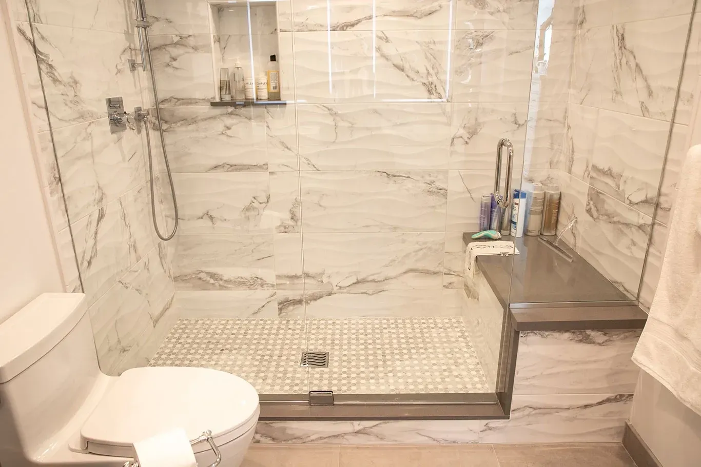 A bathroom with a toilet and a walk in shower.