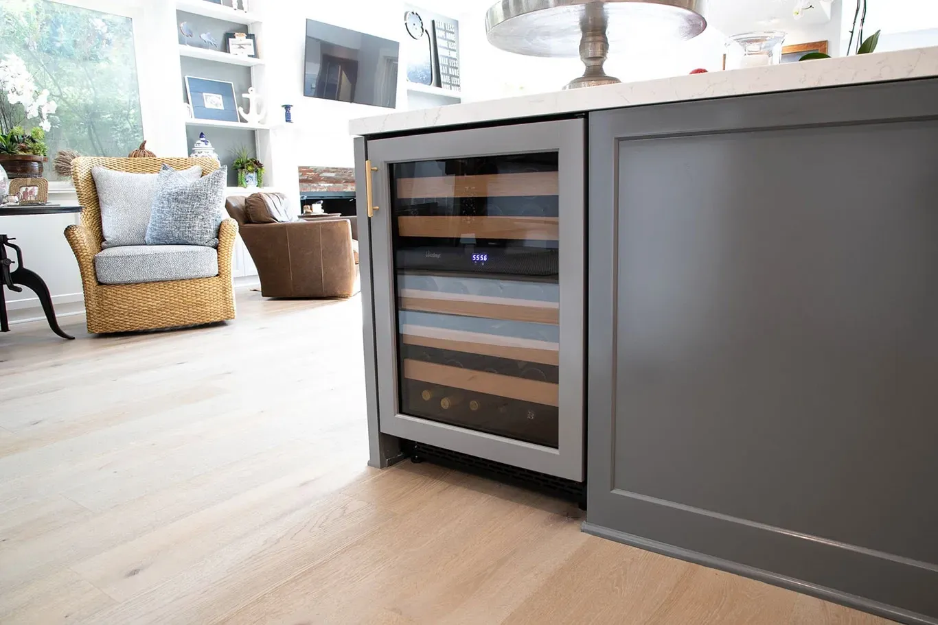 There is a wine cooler in the middle of the kitchen.