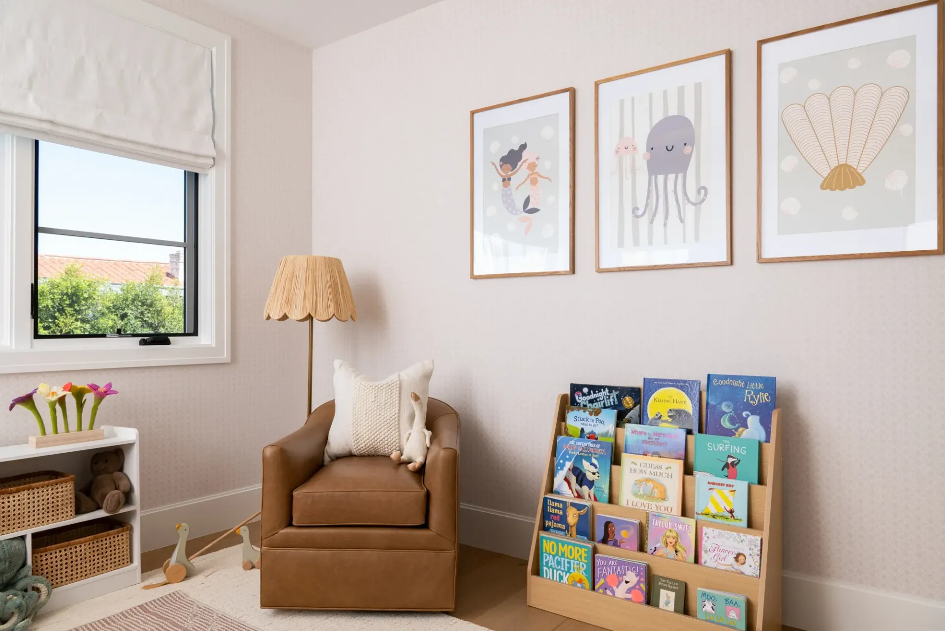 A child 's room with a chair , bookshelf , and window.
