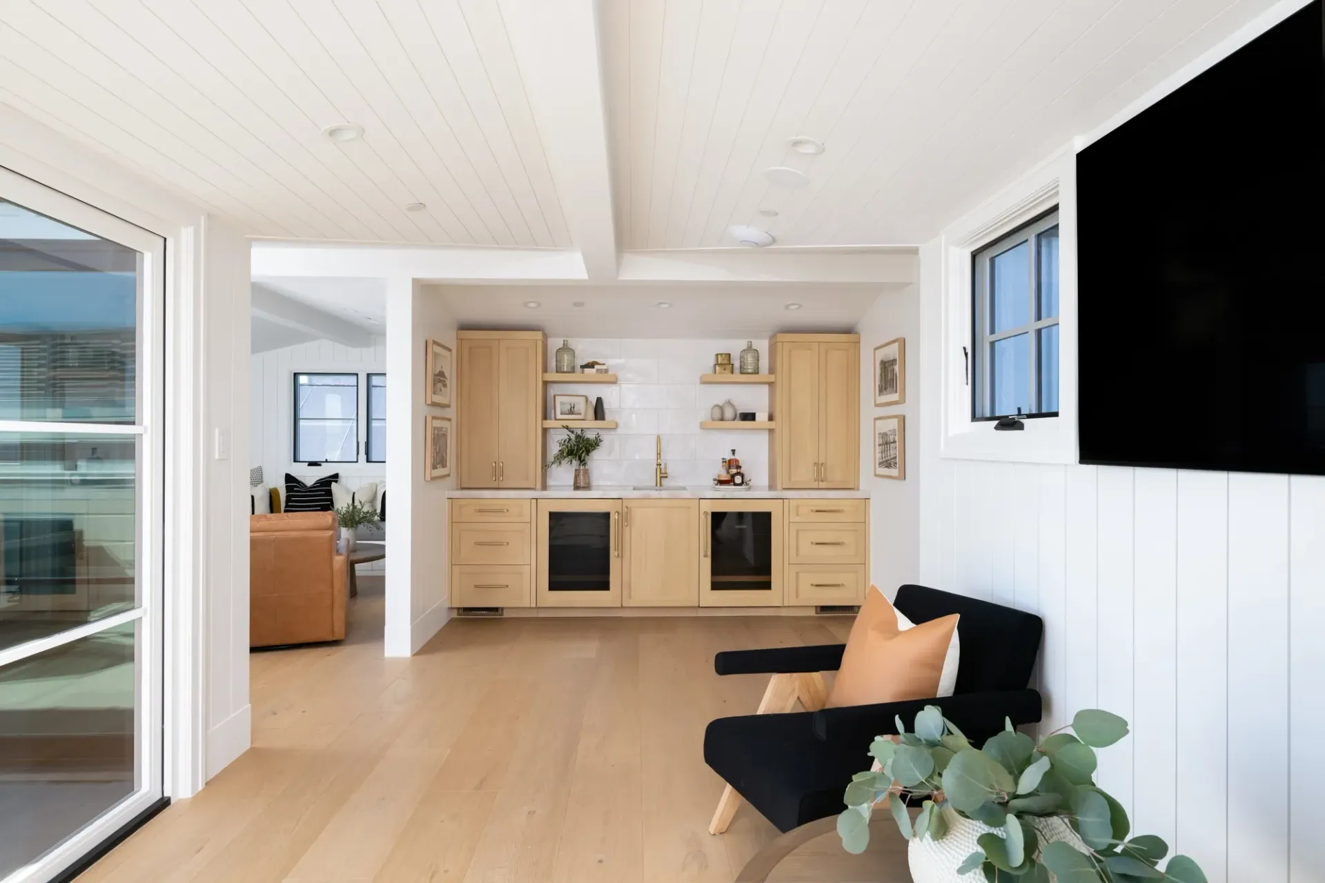A living room with a couch , chair , and television.