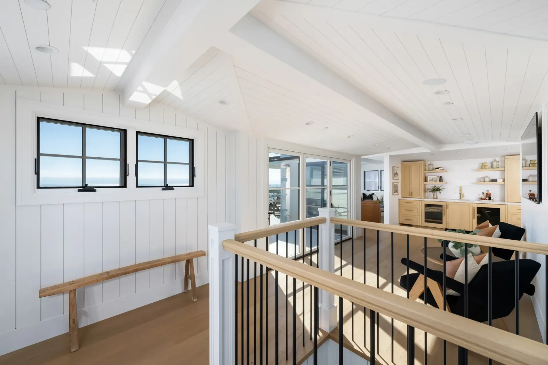 A person is sitting at a table in a room with a balcony.