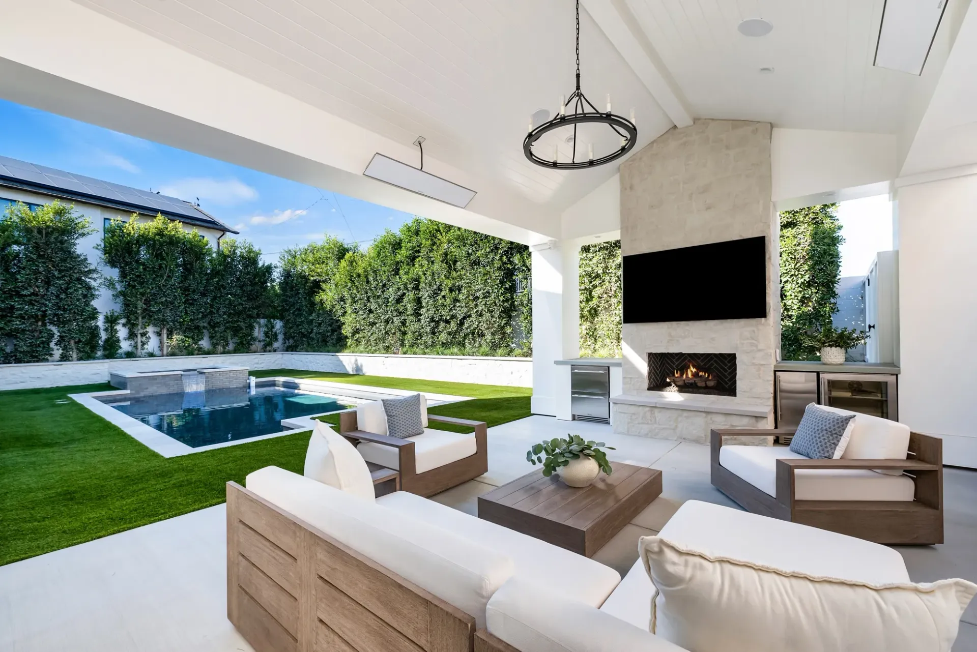 A living room with a fireplace and a swimming pool