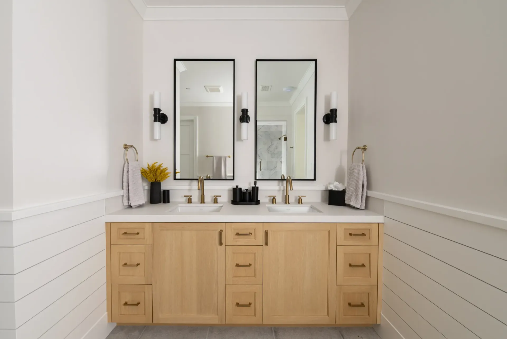 A bathroom with two sinks and two mirrors.