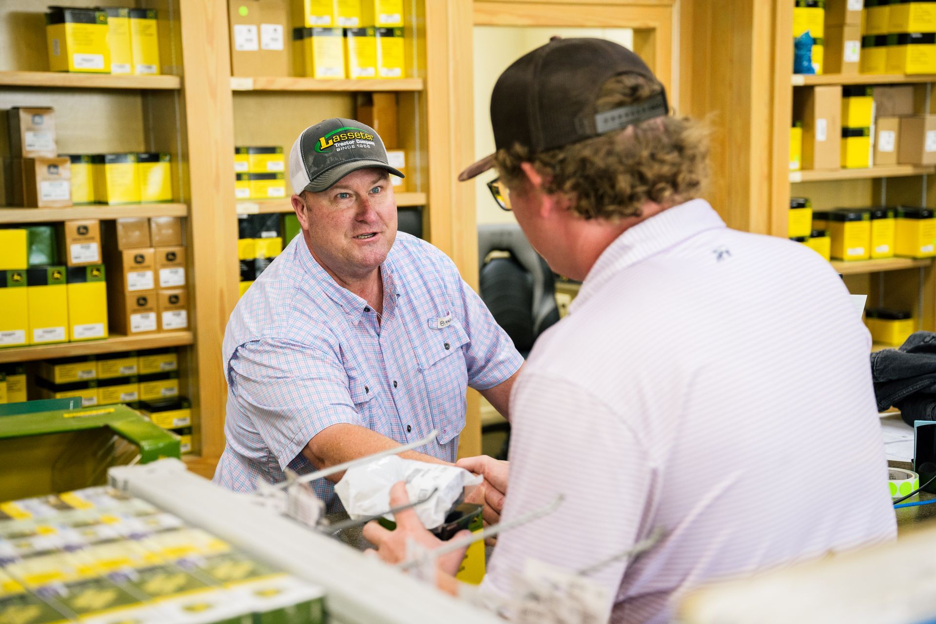 Two men are talking to each other in a store.