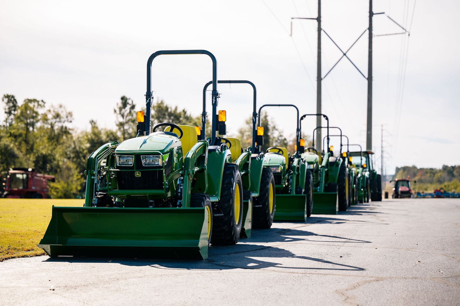 A man is driving a green John Deere tractor
