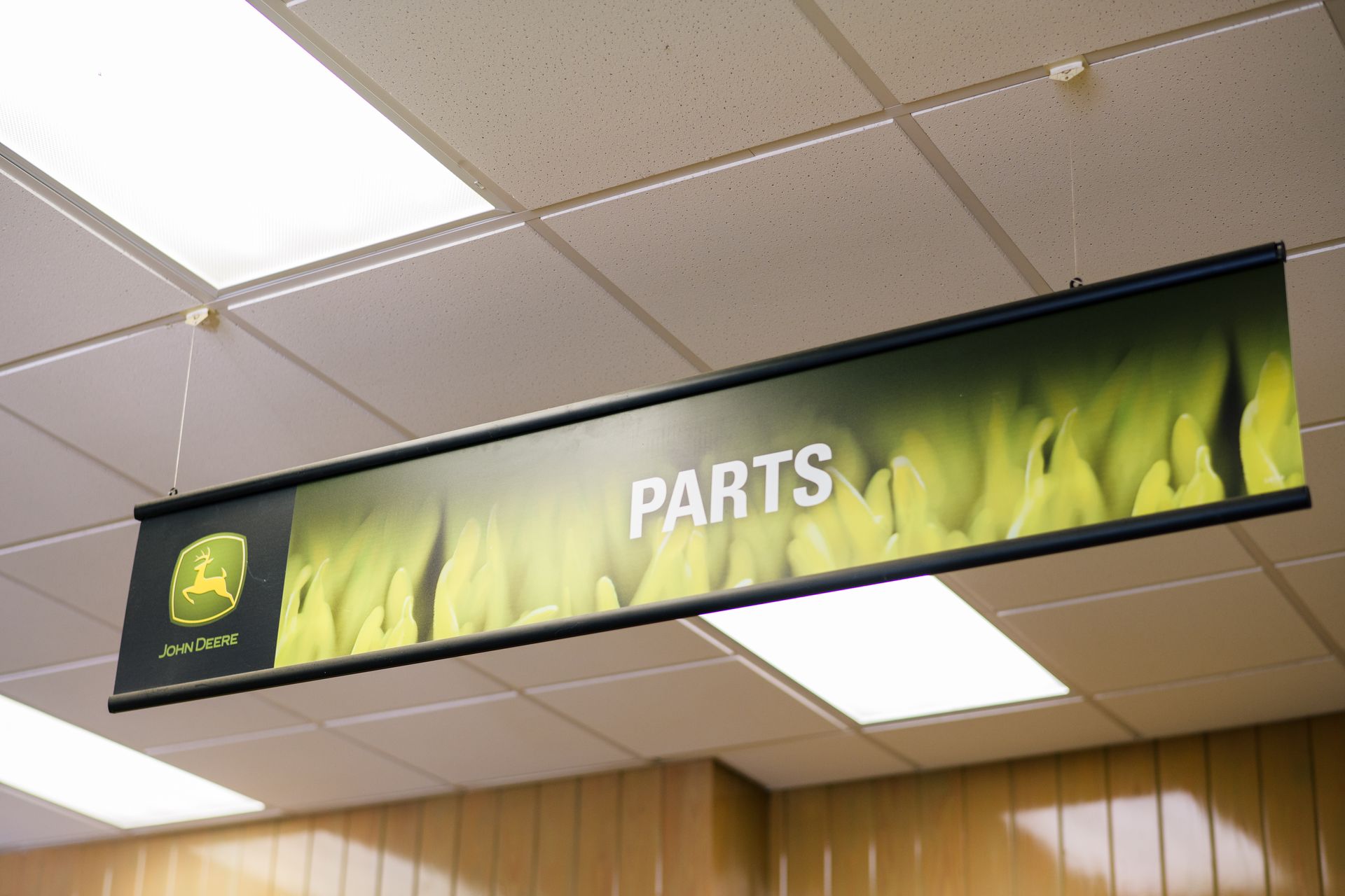 A sign hanging from the ceiling that says Parts