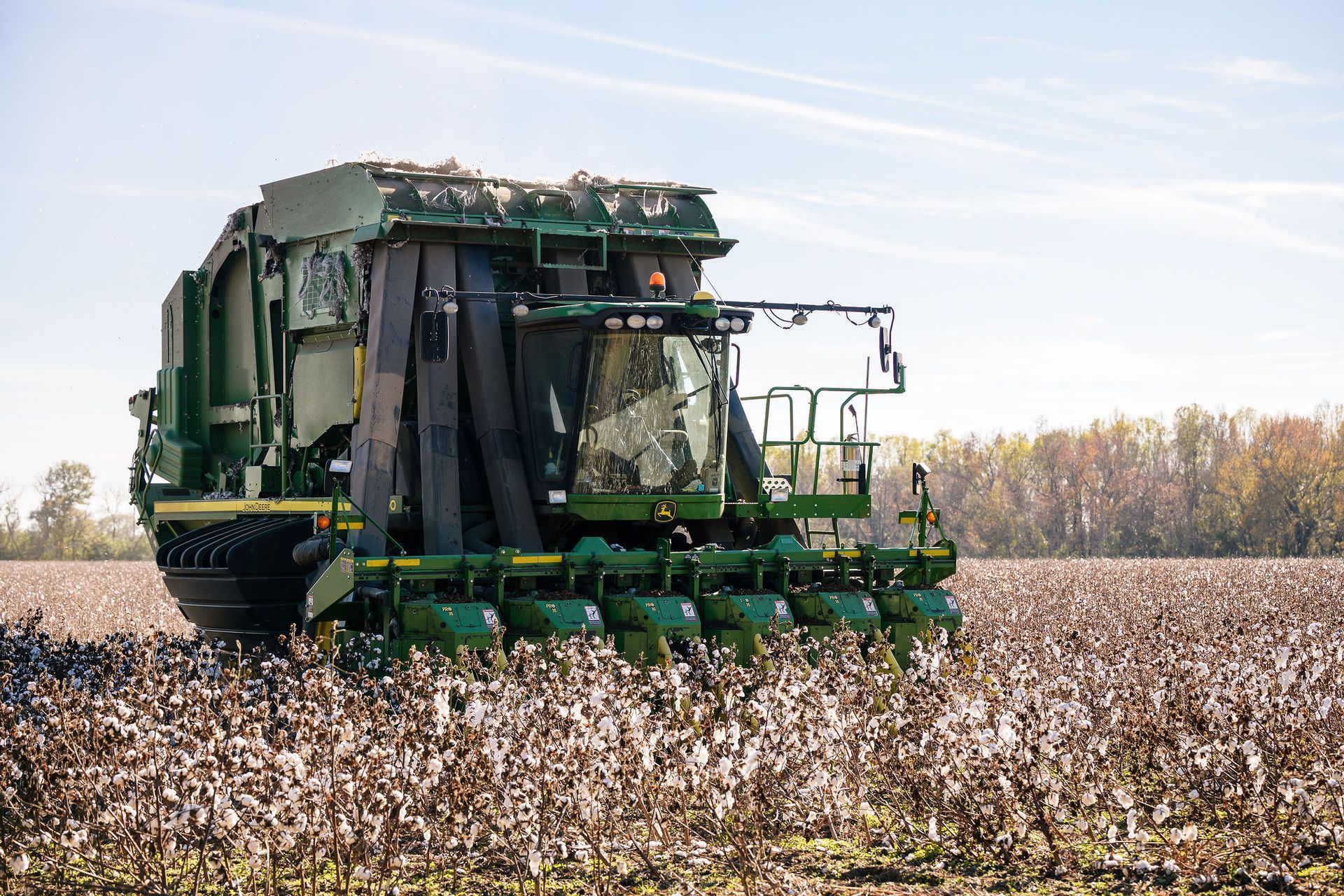 A John Deere cotton picker in a cotton field
