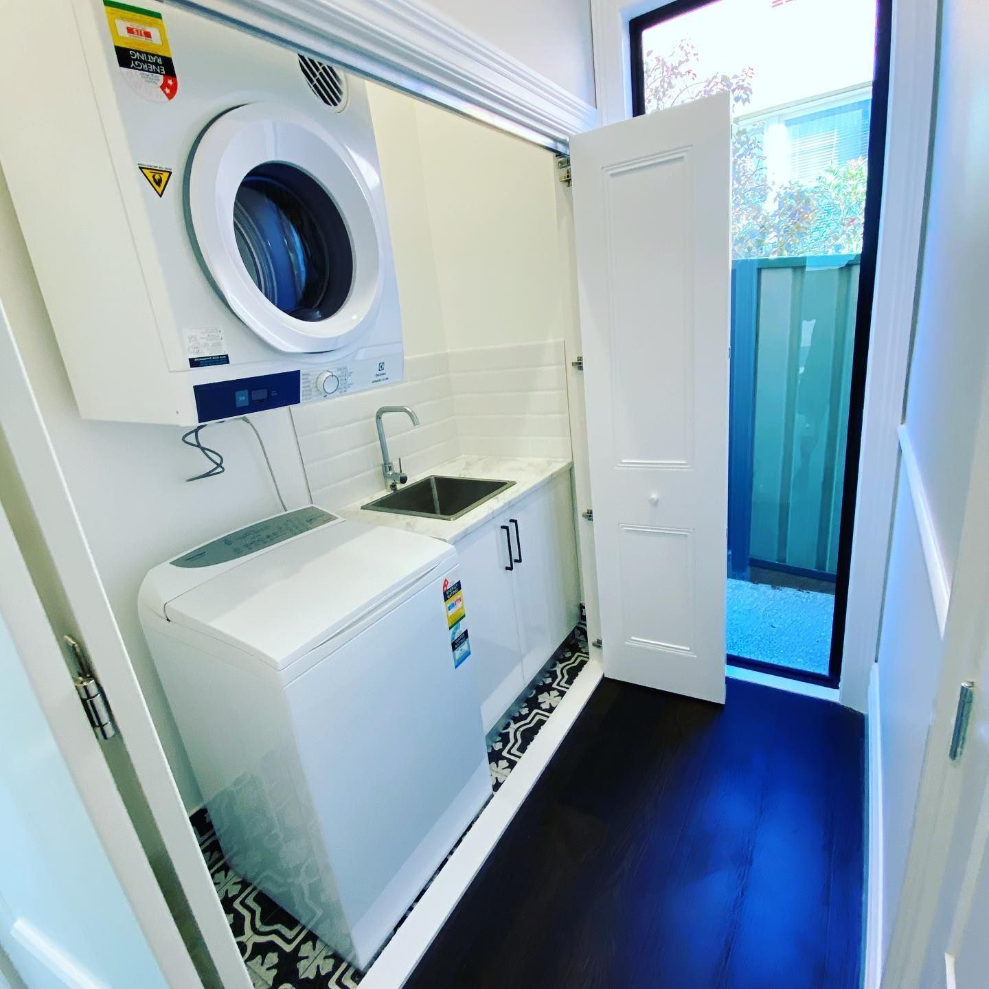 White Laundry Room With Blue Glass Window - Laundry & Bathroom Renovations in Newcastle, NSW