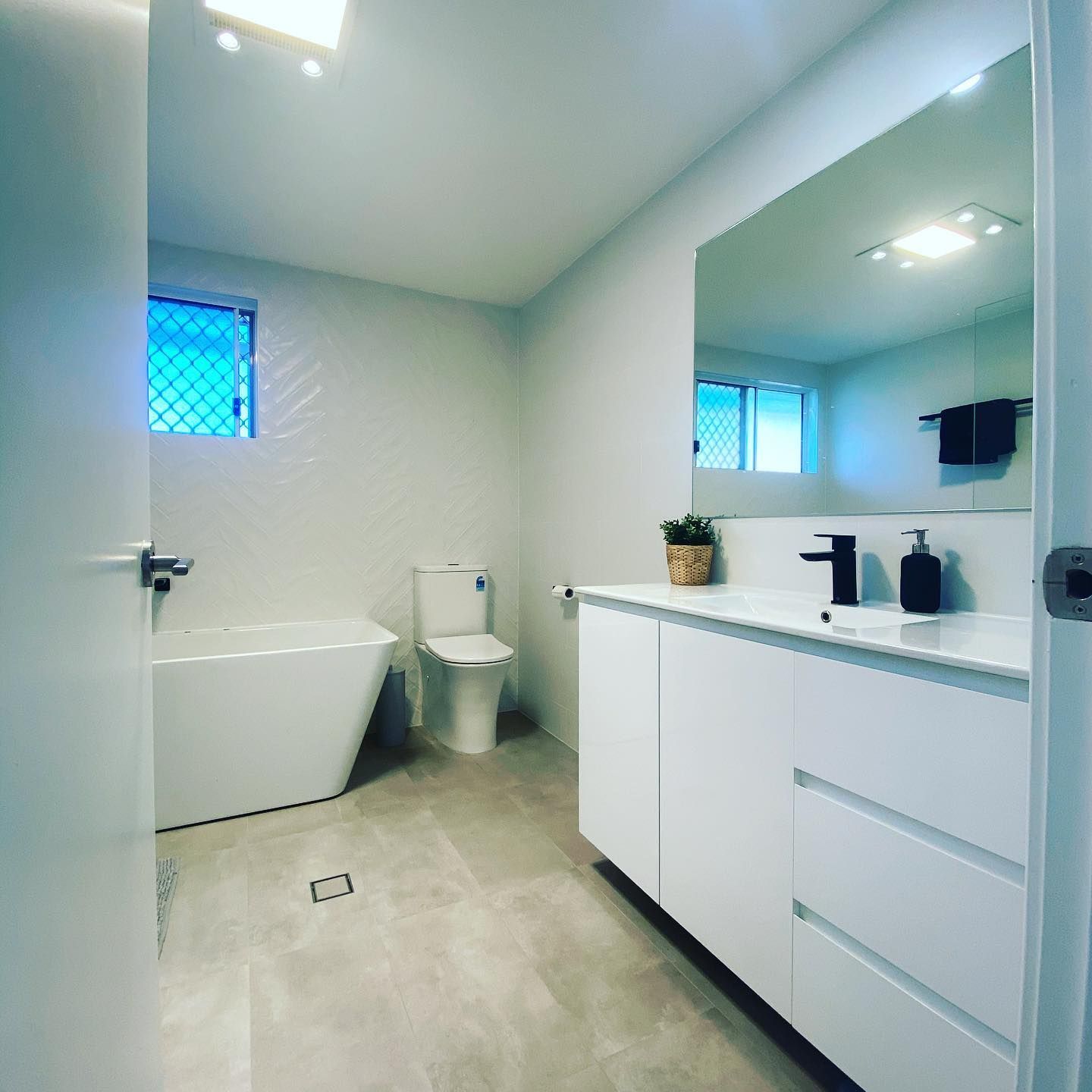 White Bathroom With Big Mirror And Cabinet - Professional Builder in Lake Macquarie, NSW