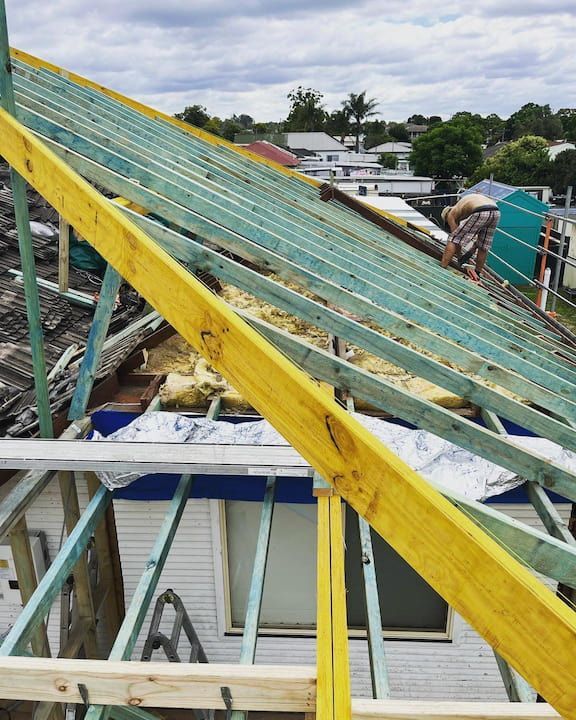 Man Repairing The Roof Of A House - Leading Building Company in Cooranbong, NSW