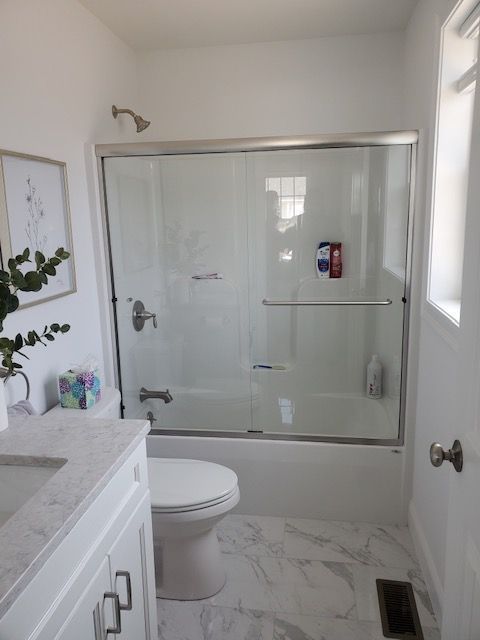 A bathroom with a toilet a sink and a bathtub