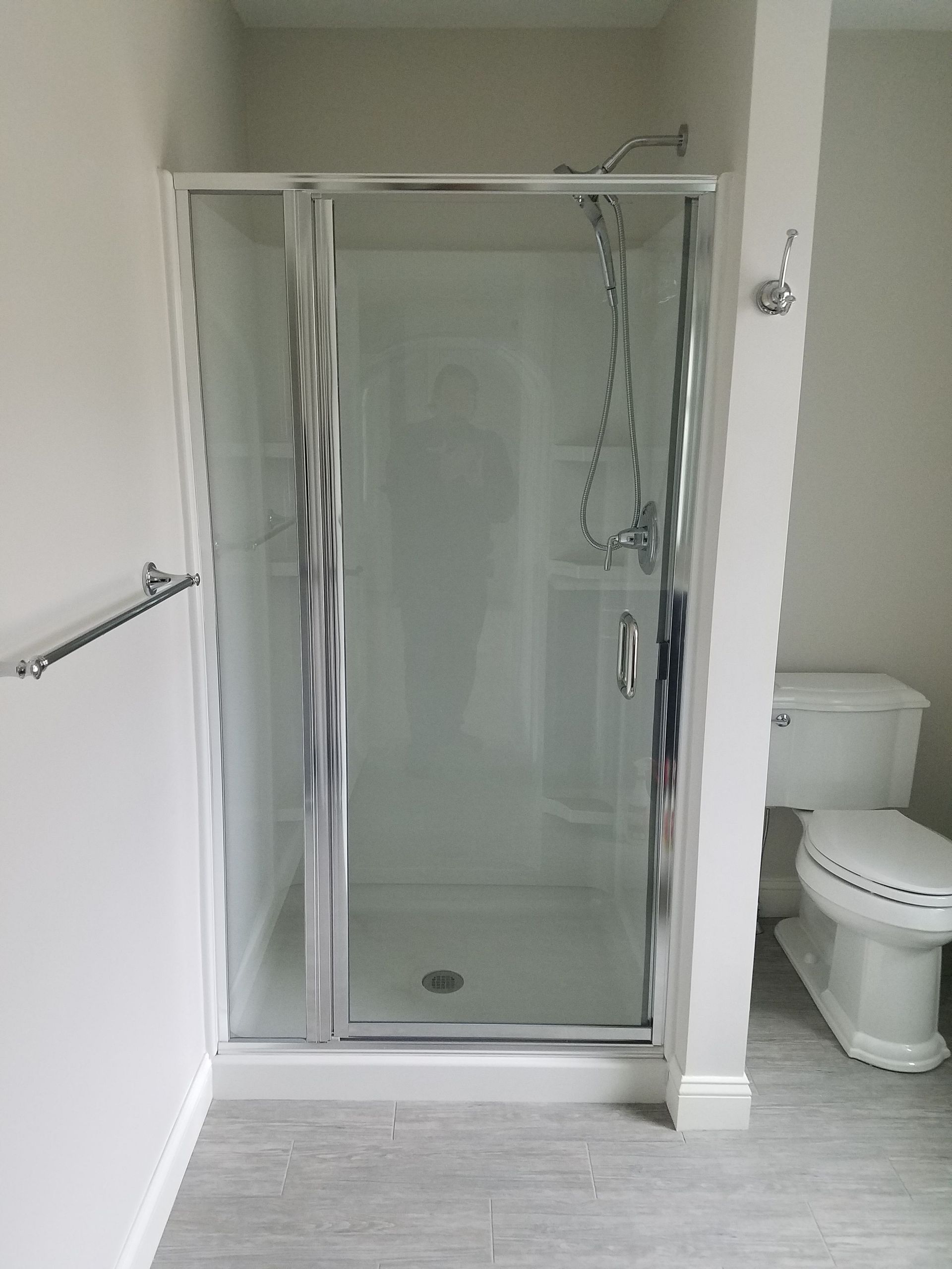 A bathroom with a toilet and a shower stall.