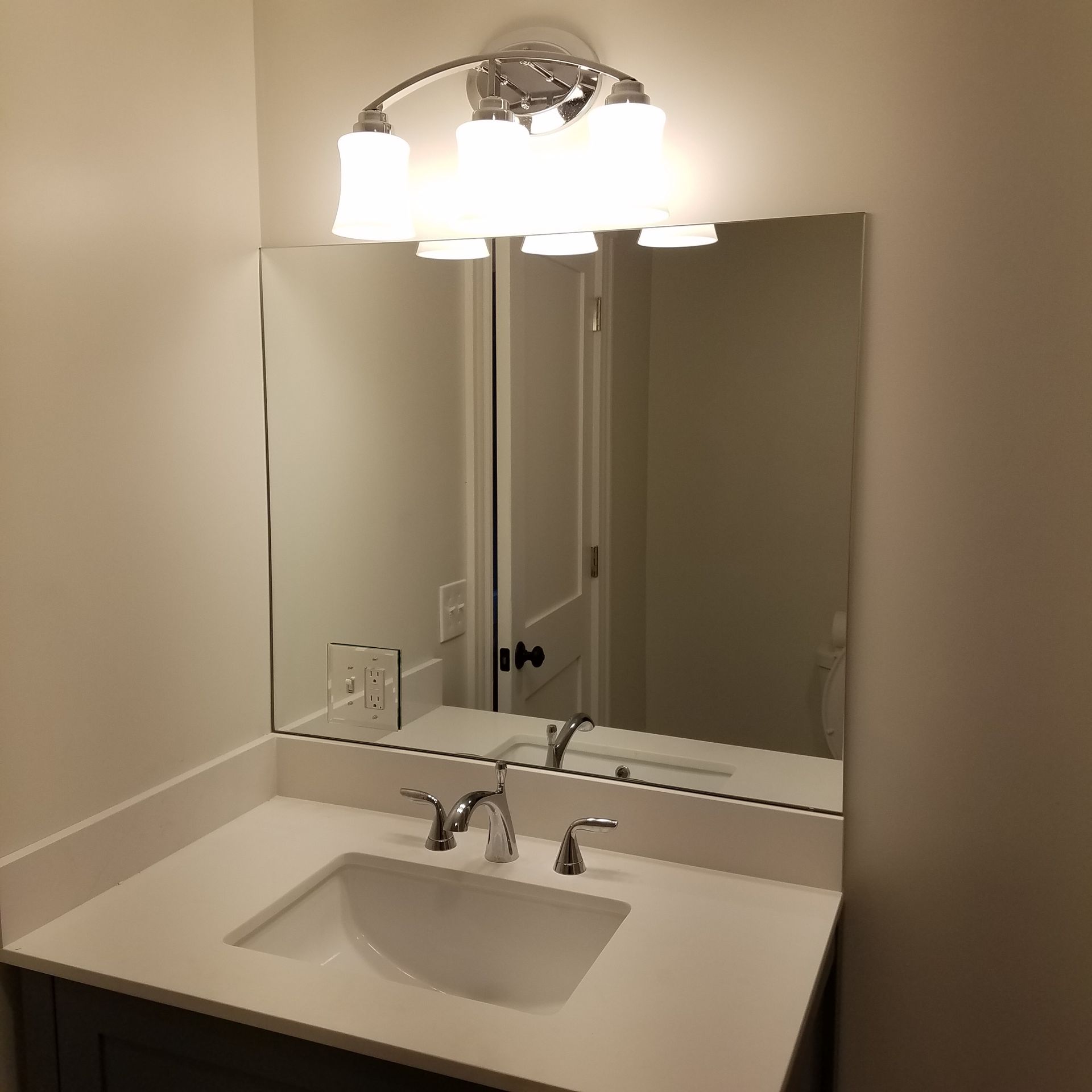 A bathroom sink with a mirror above it