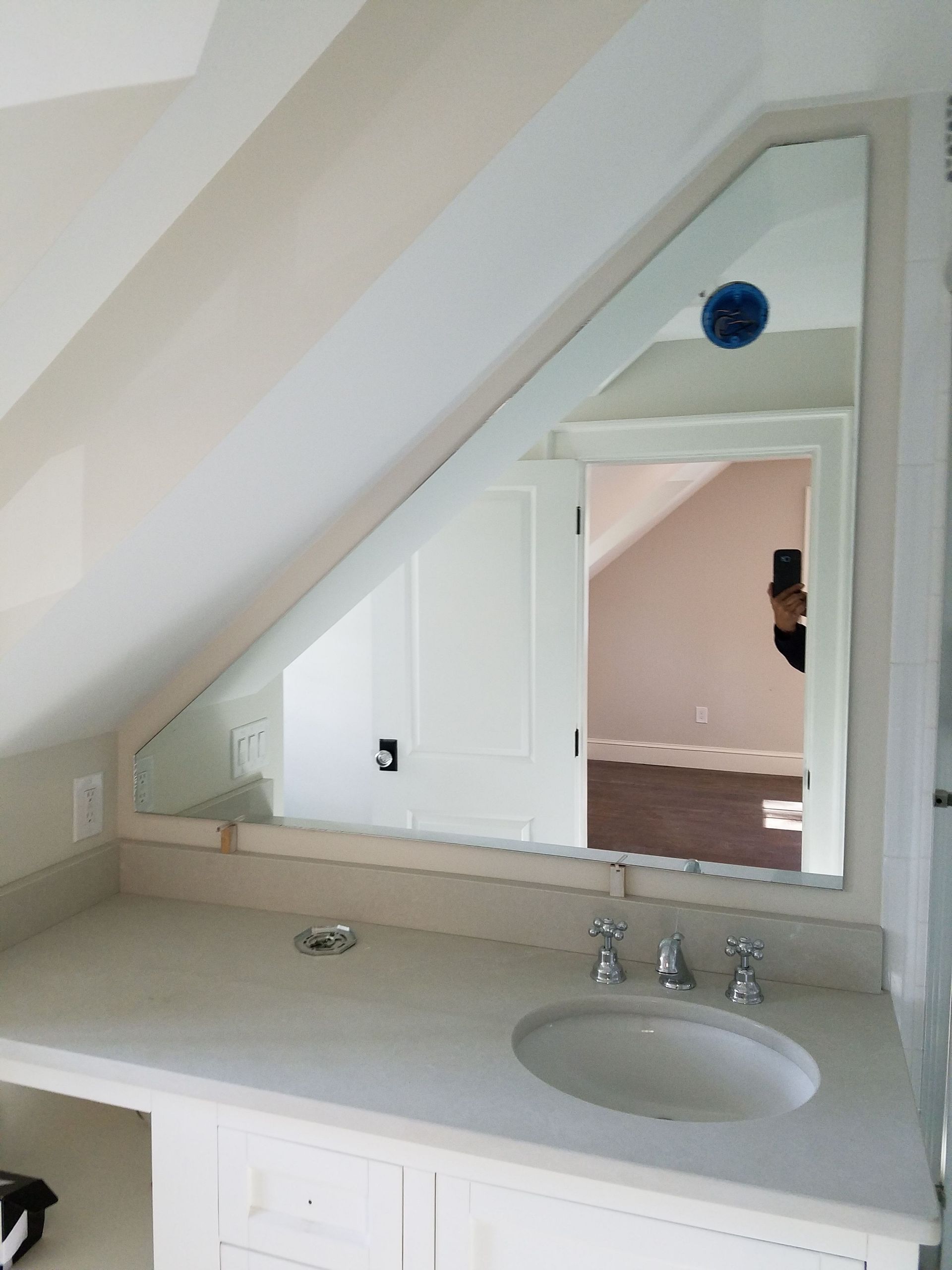 A bathroom with a sink and a mirror on the wall