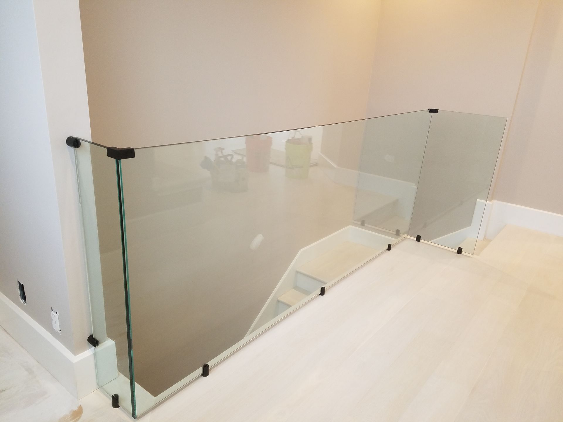 A glass railing on a staircase in a house.