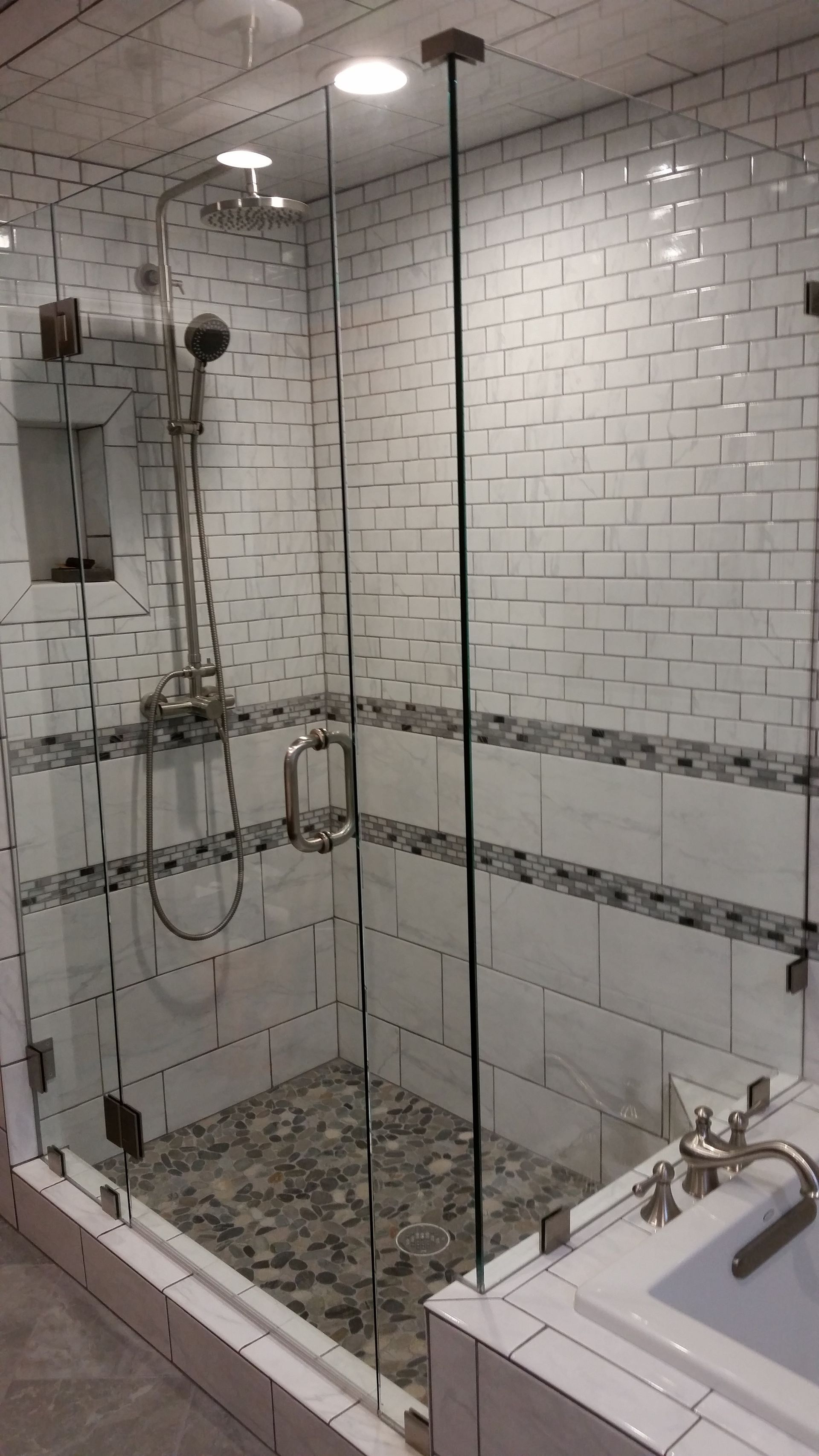 A bathroom with a walk in shower and a bathtub.