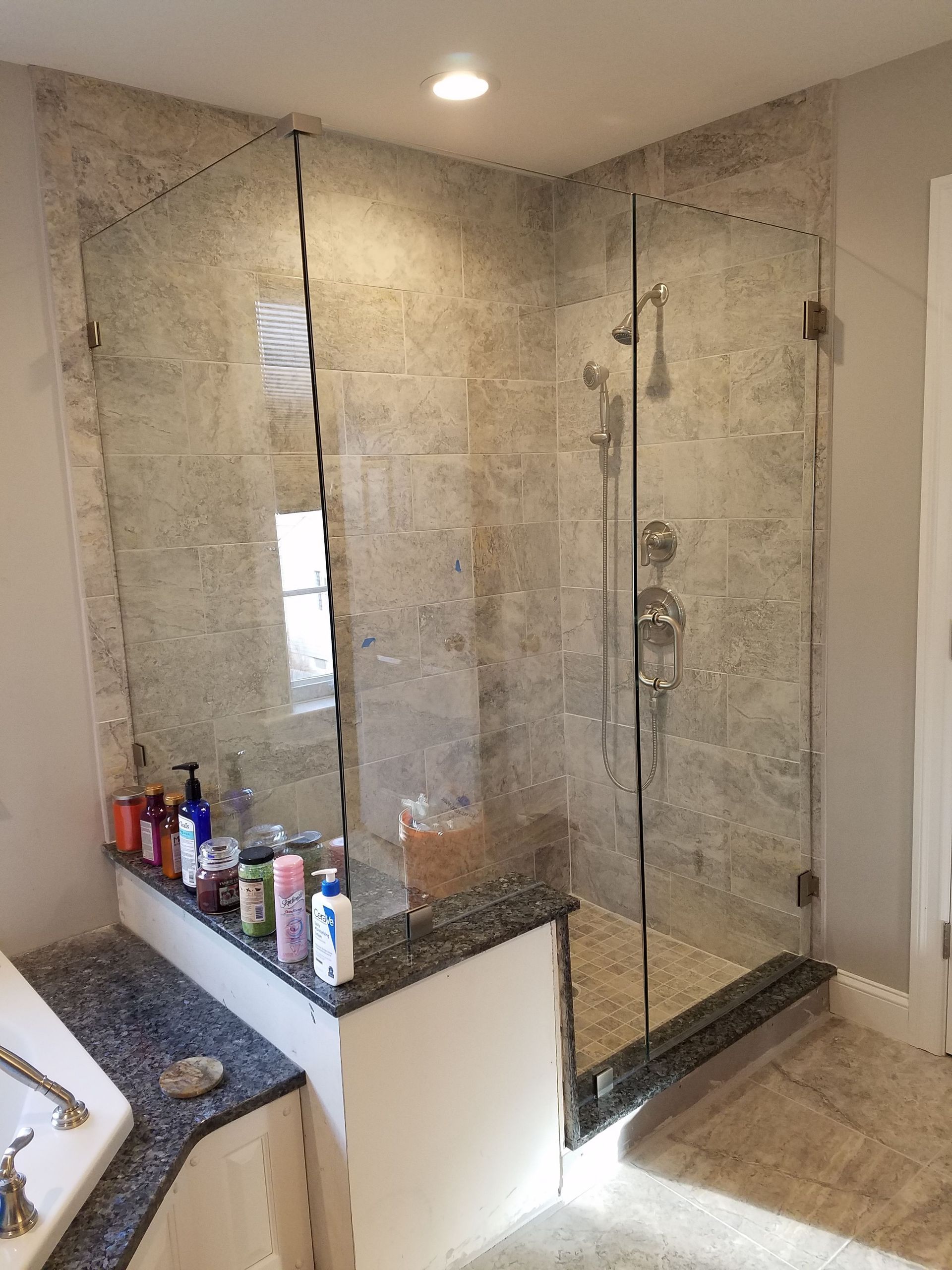 A bathroom with a walk in shower and a bathtub.