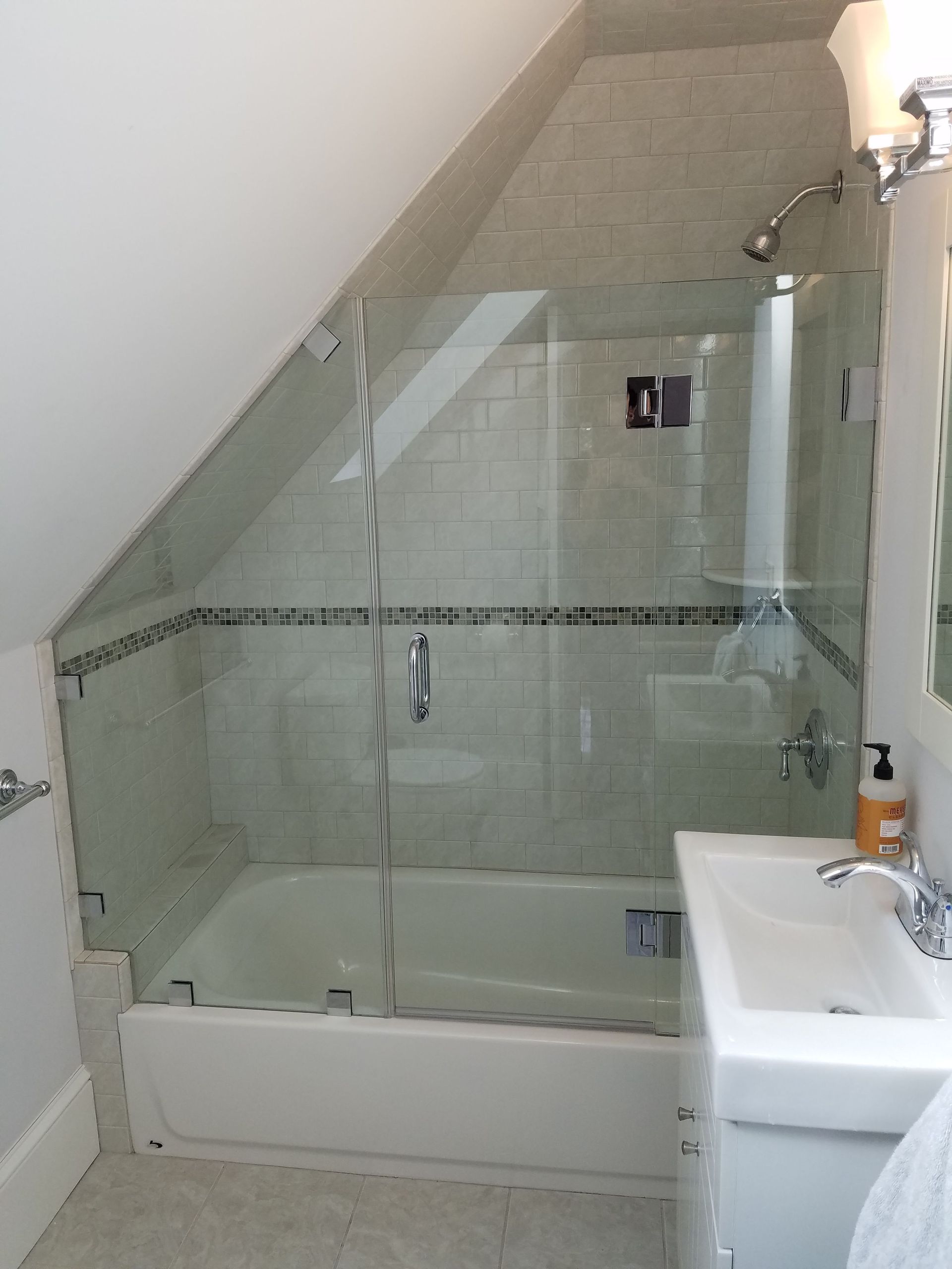 A bathroom with a bathtub , sink and shower.