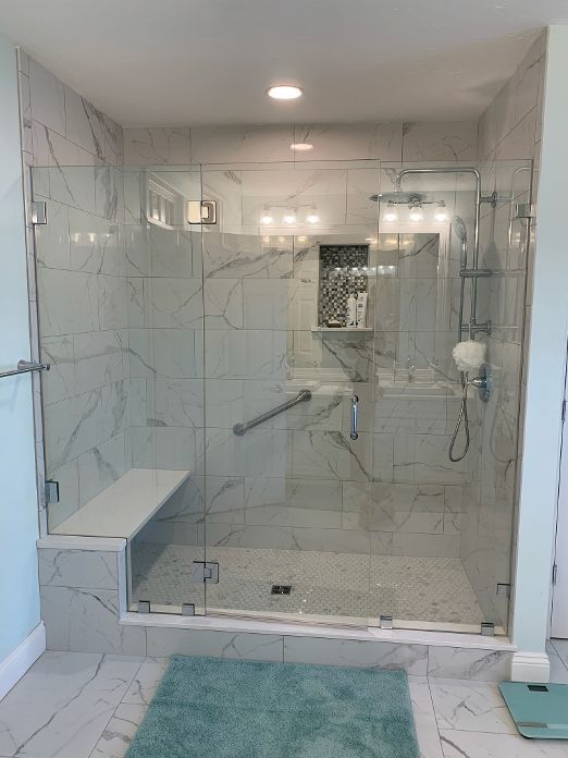 A bathroom with a walk in shower and a bathtub.