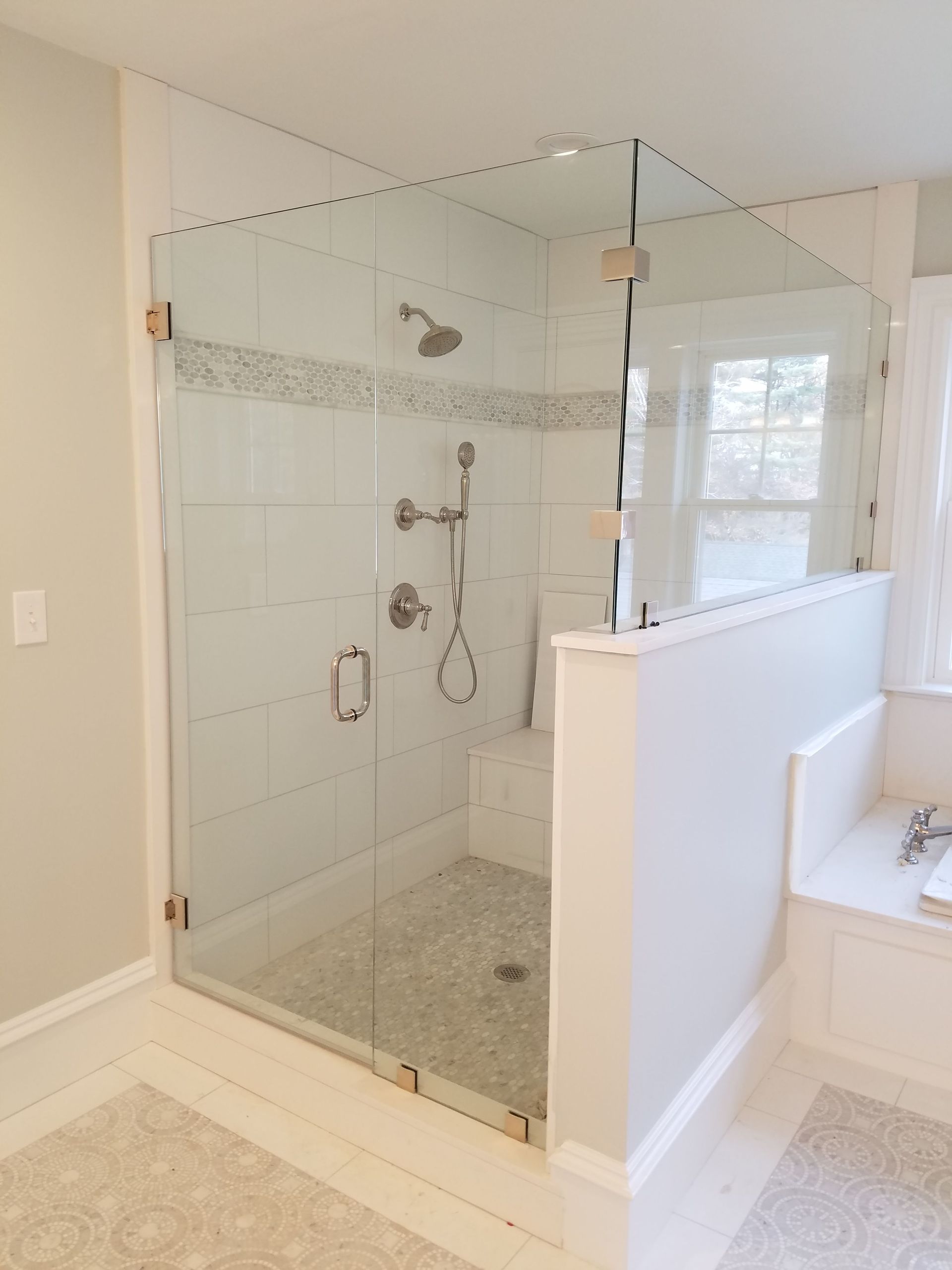 A bathroom with a walk in shower and a bathtub.