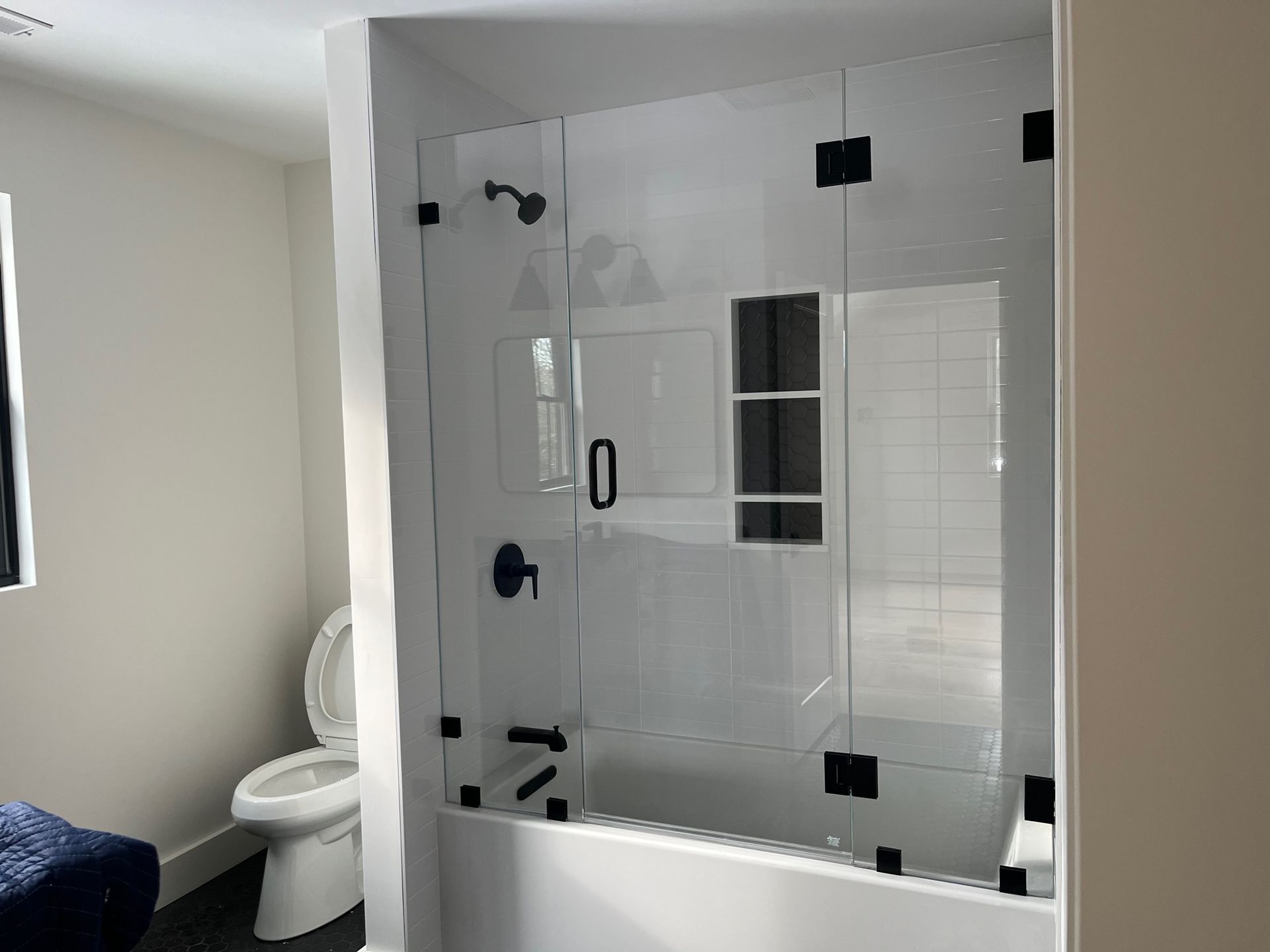 A bathroom with a toilet , shower and bathtub.