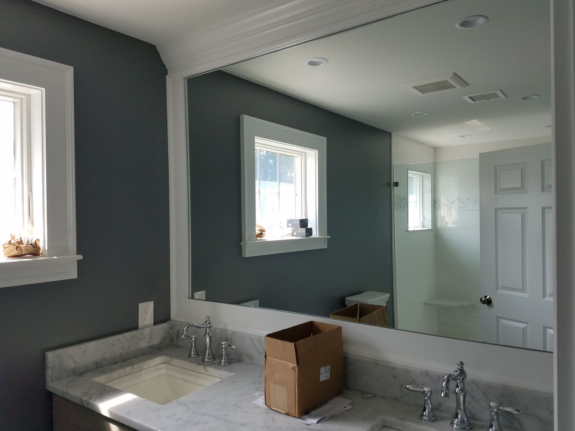 A bathroom with a sink and a large mirror