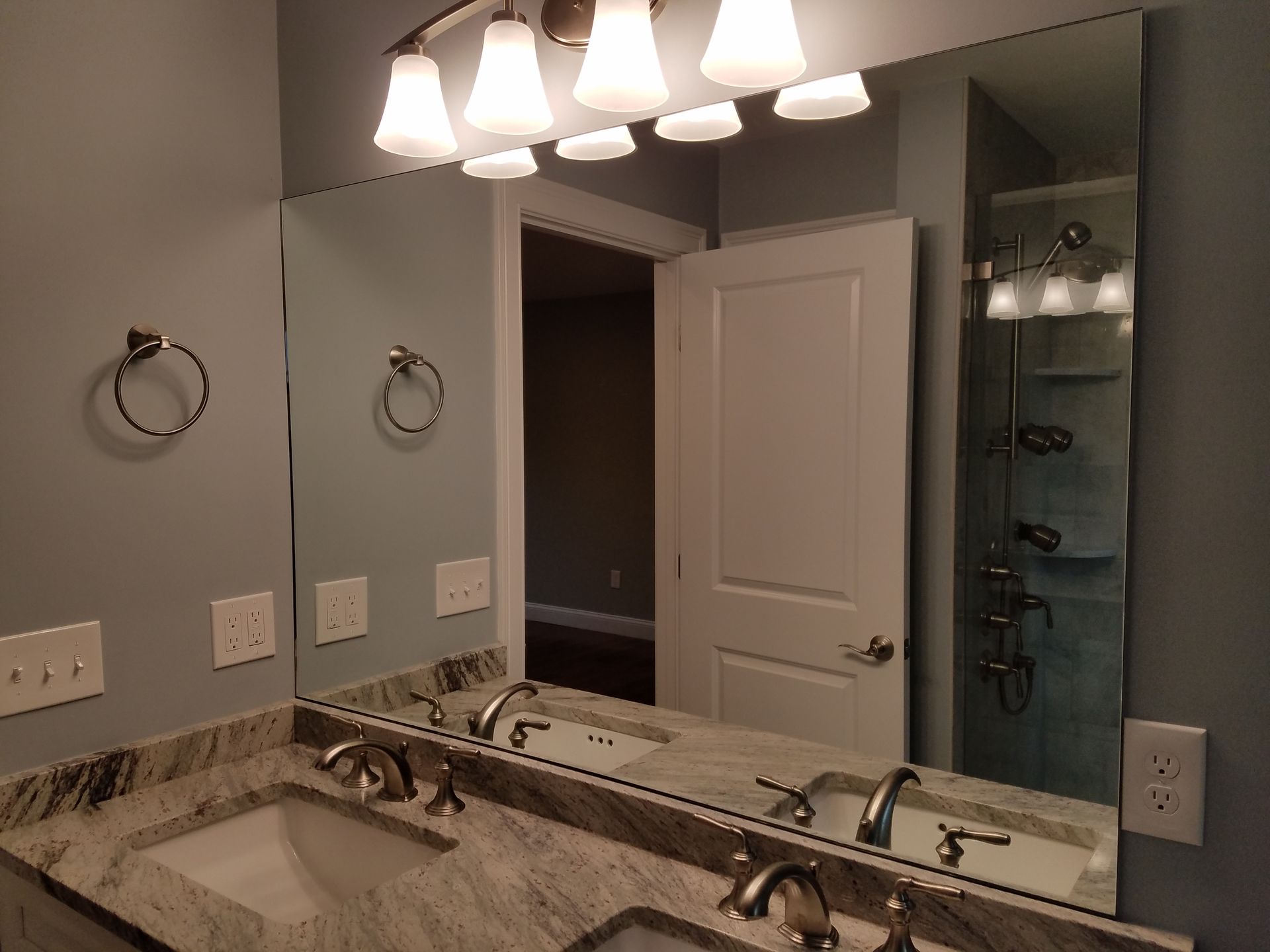 A bathroom with two sinks and a large mirror.