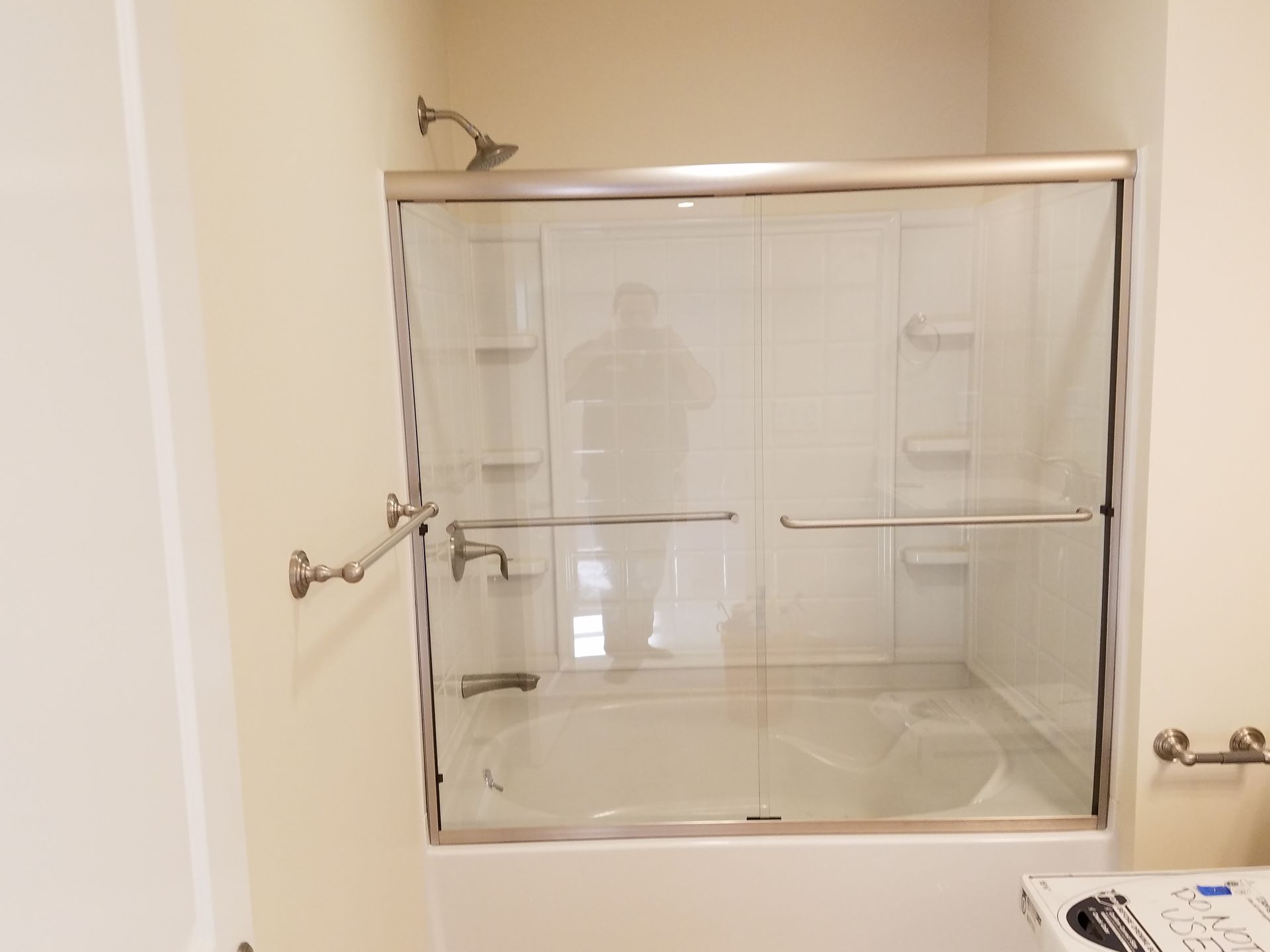 A bathroom with a sliding glass shower door and a bathtub.