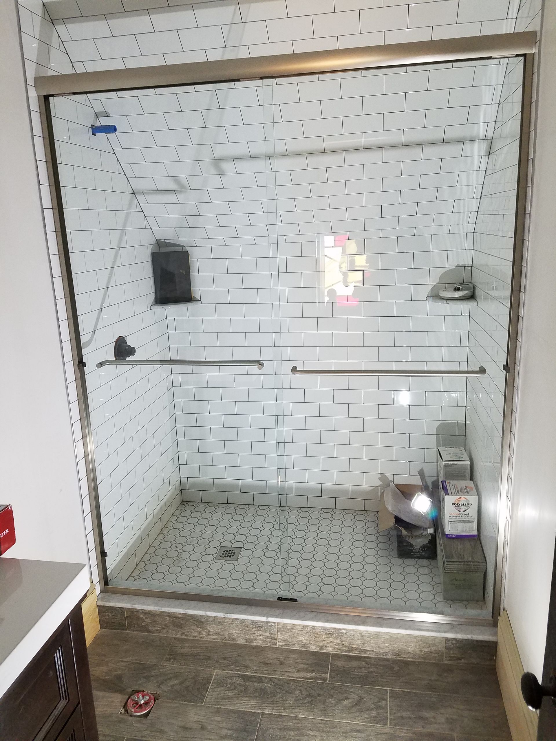 A bathroom with a sliding glass shower door and a sink.