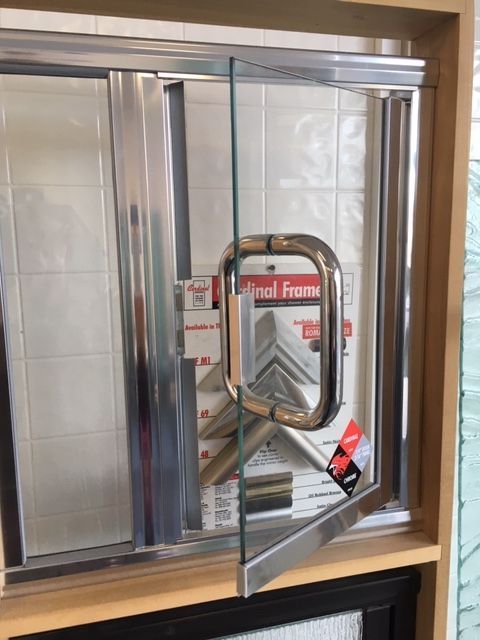 A glass door with a stainless steel frame