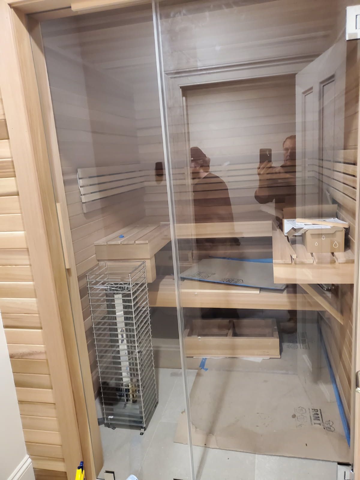 A man is taking a picture of himself in a sauna.