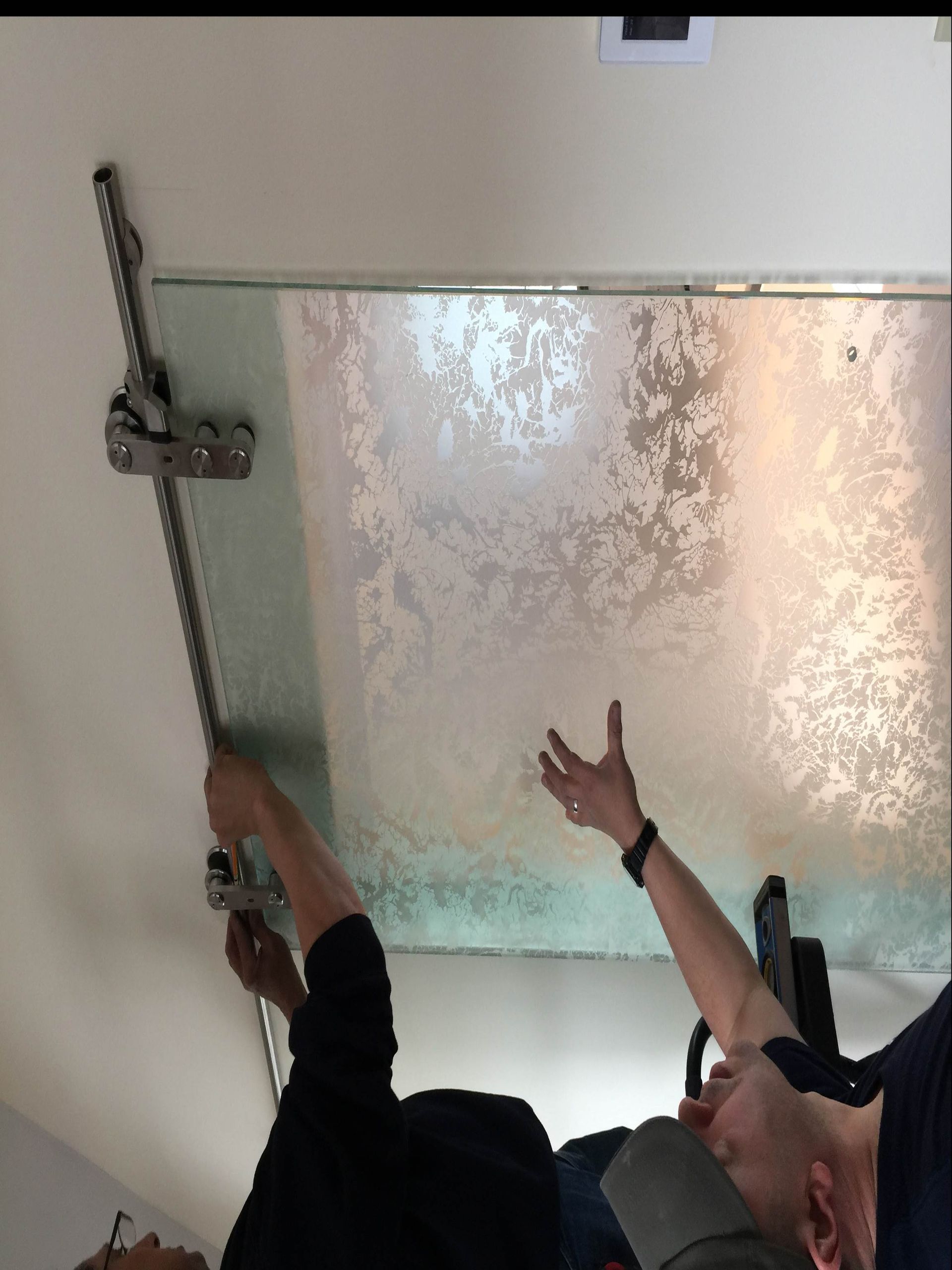 A man is measuring a ceiling with a tape measure