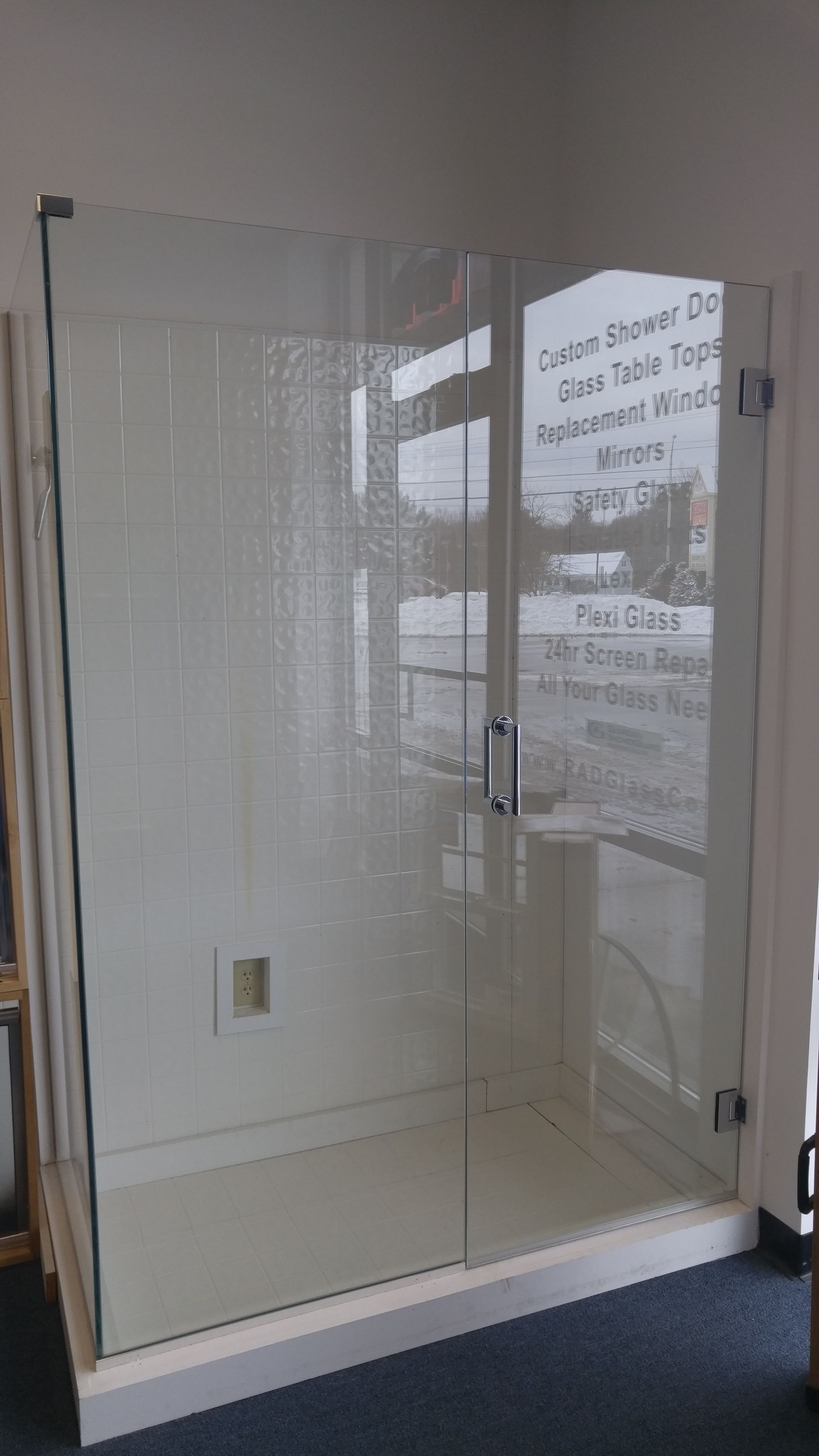 A shower stall with a glass door in a bathroom.