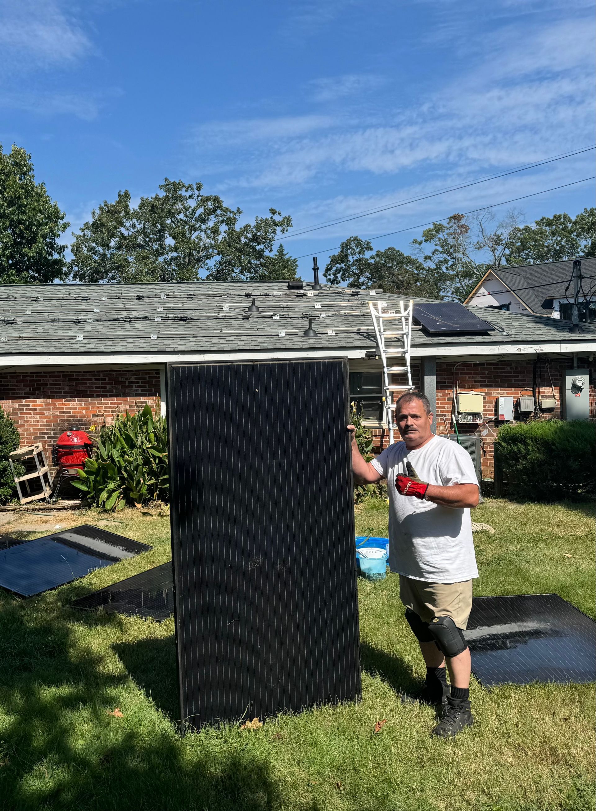 Solar panels against a bright blue sky with fluffy white clouds.