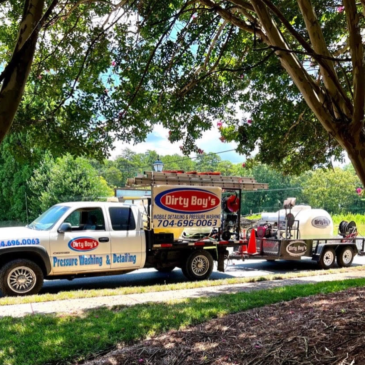 A white truck is parked in front of a restaurant.