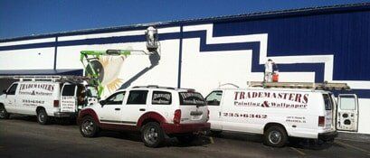 Man painting a wall at a construction site — Commercial Painting in Belleville and Collinsville, IL