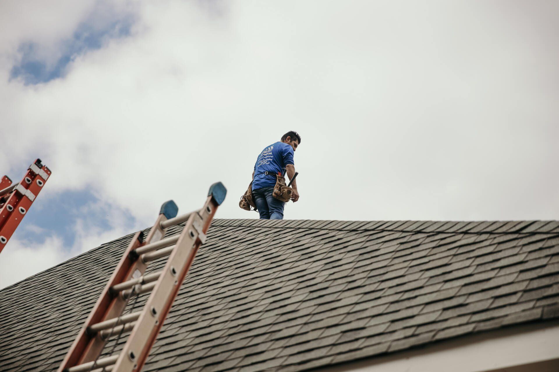 Roofer inspecting shingle roof
