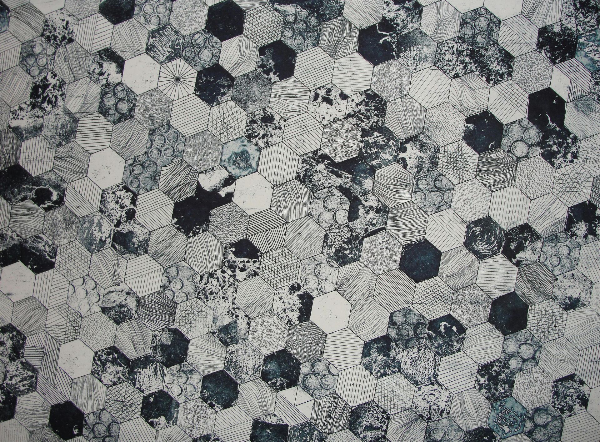 Abstract pattern of interconnected hexagons in shades of white, gray, and blue.
