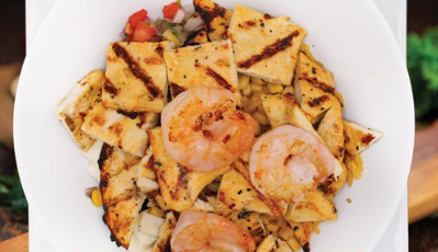 Grilled chicken and shrimp bowl with corn and pico de gallo.