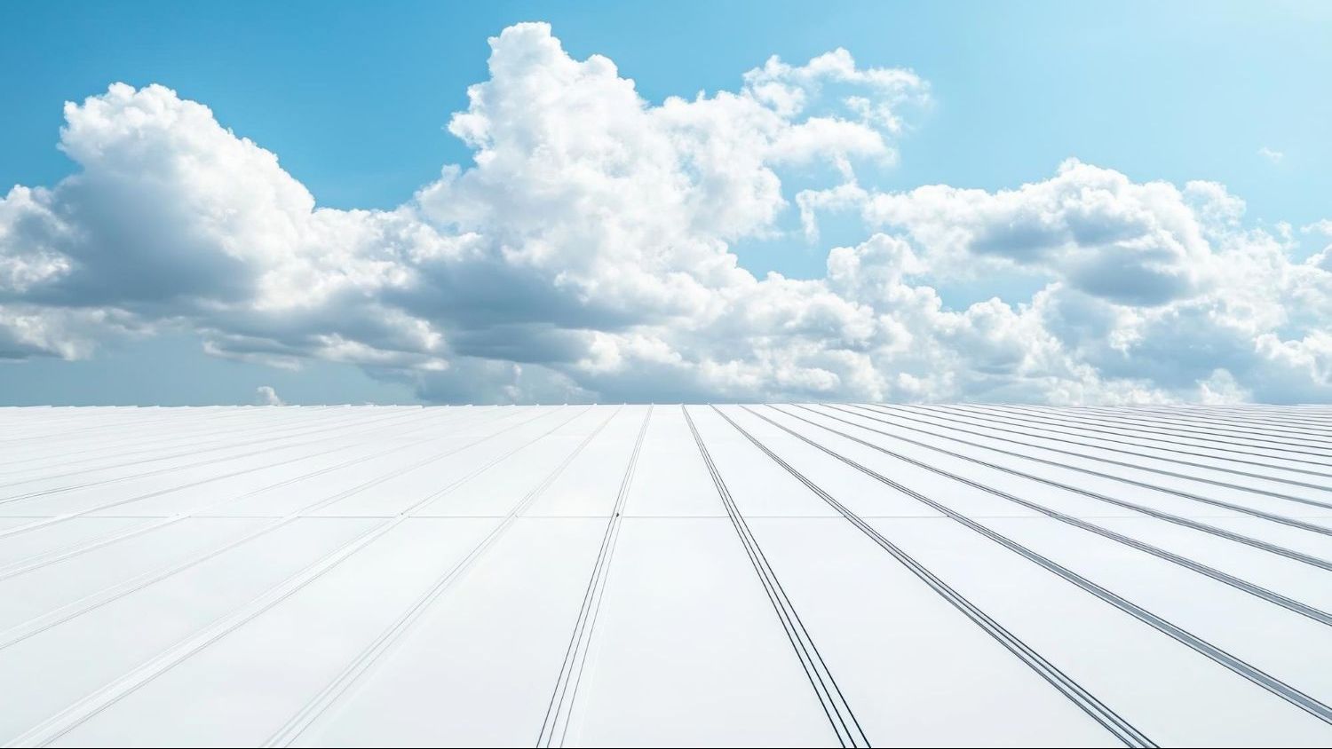 White wooden planks receding to the horizon under a blue sky filled with puffy white clouds.