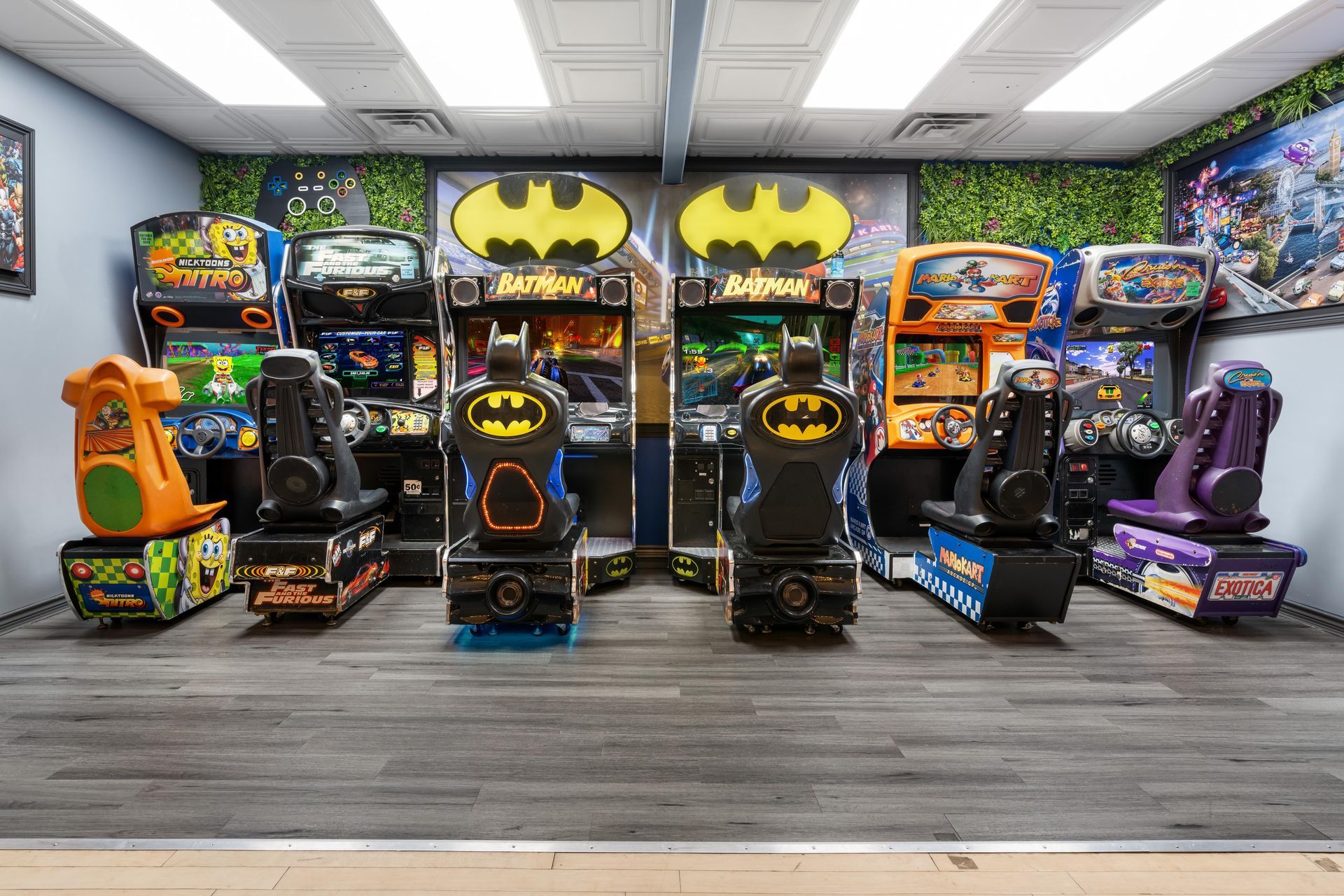 A room filled with lots of arcade games and a gas pump.