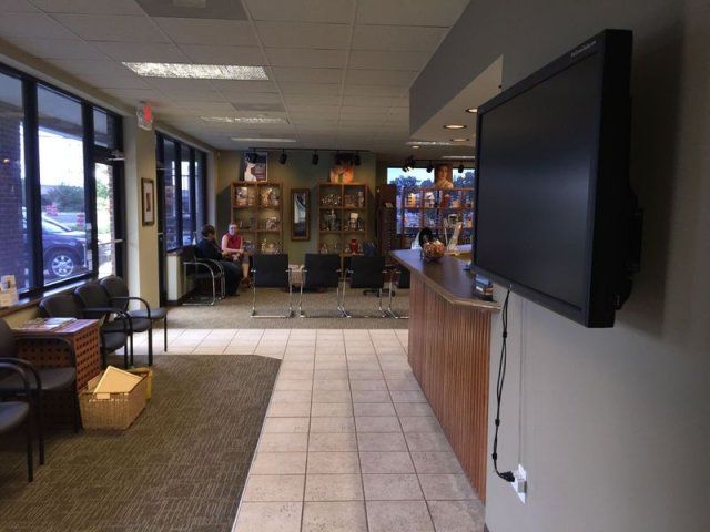 A waiting room with a flat screen tv mounted on the wall
