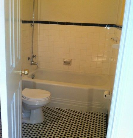 A bathroom with a toilet , bathtub and shower