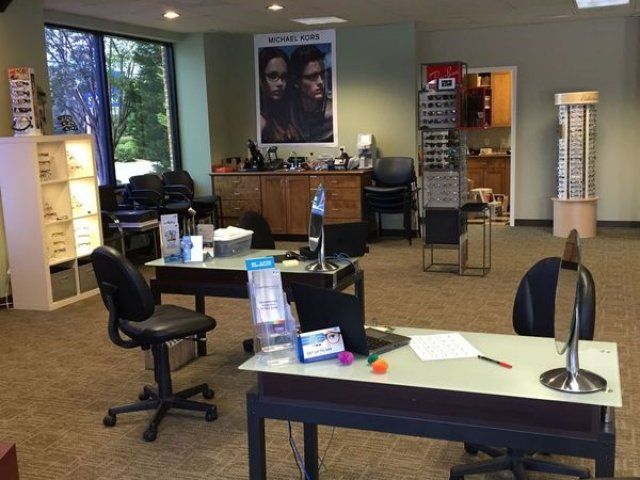 A room with a poster on the wall that says michael kors