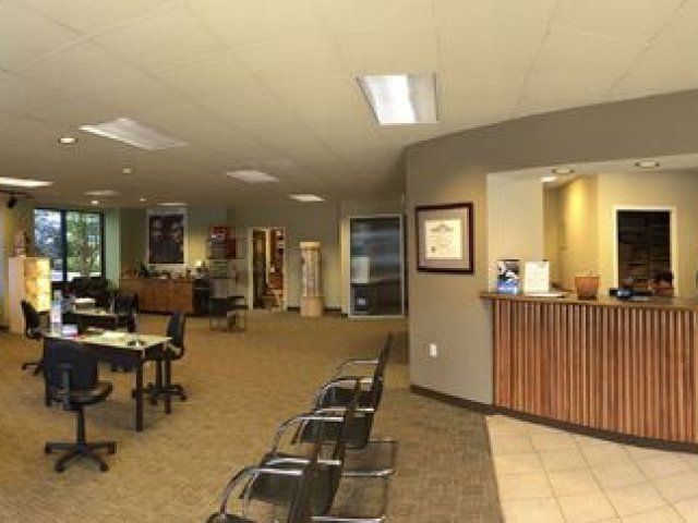 A large room with tables and chairs and a wooden counter